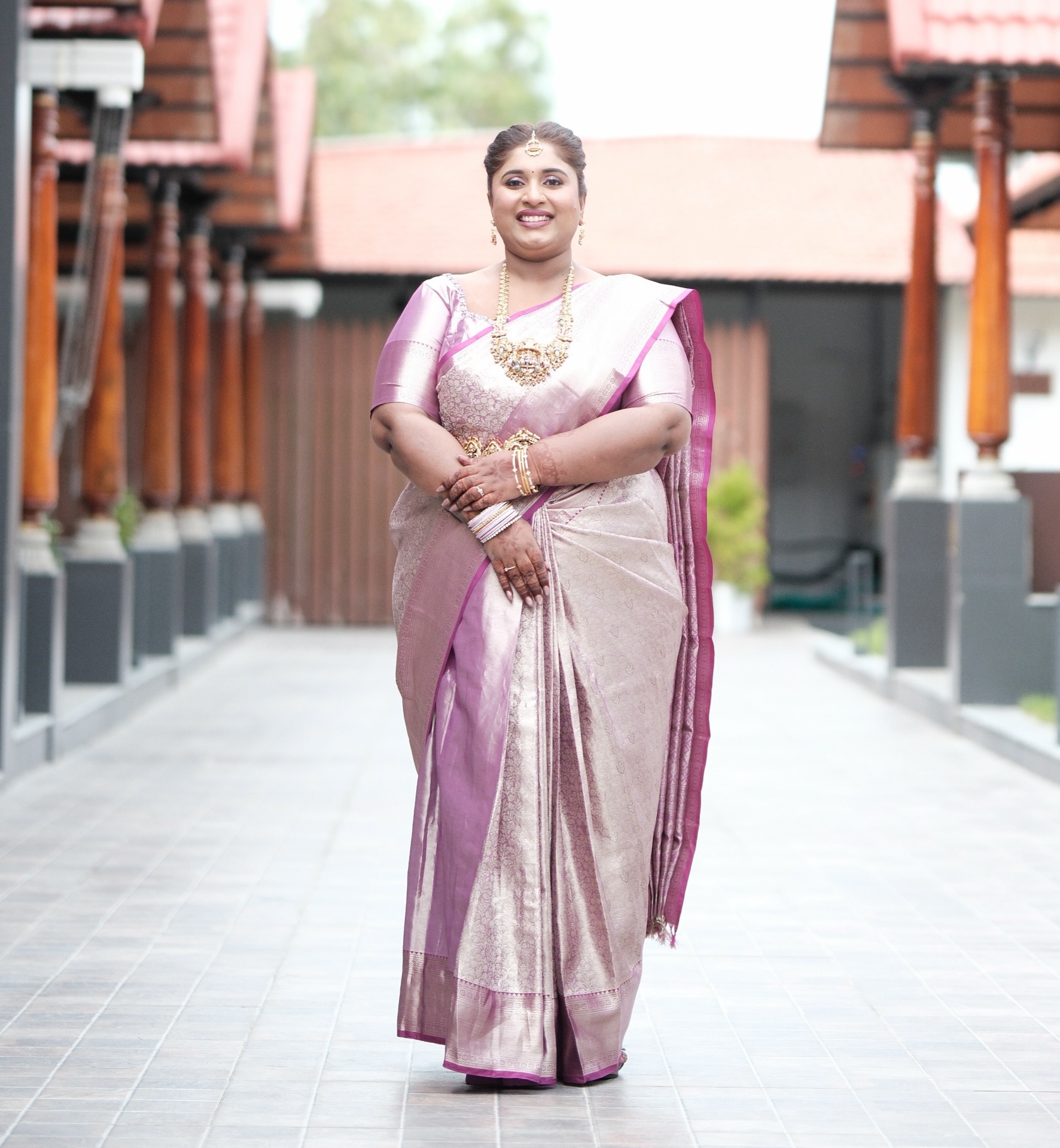 Dr. Ashvini Sundararaju walking a corridor in a lilac Kanjeevaram saree