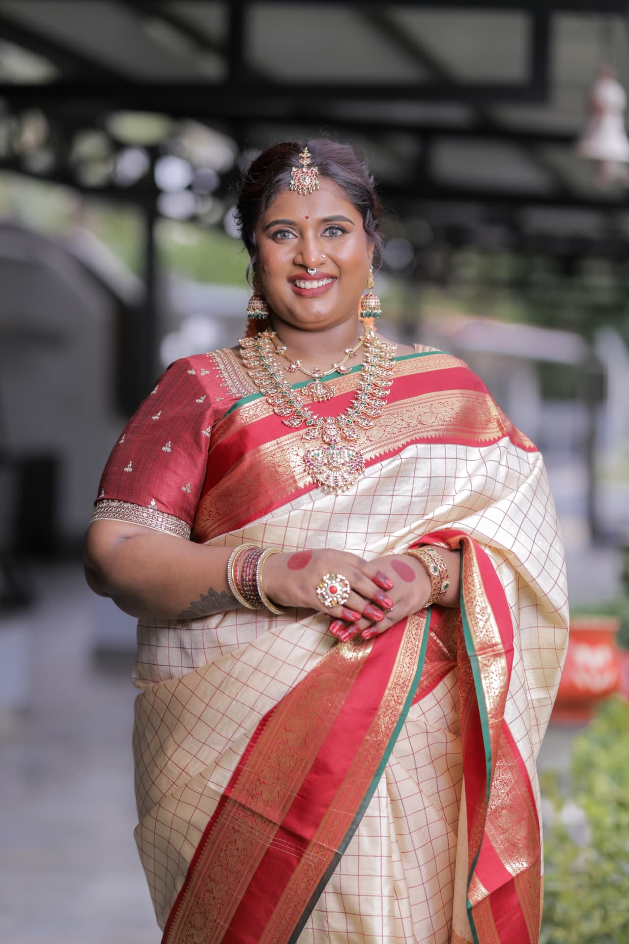 Dr. Ashvini Sundararaju in a cream Kanjeevaram saree with temple jewellery