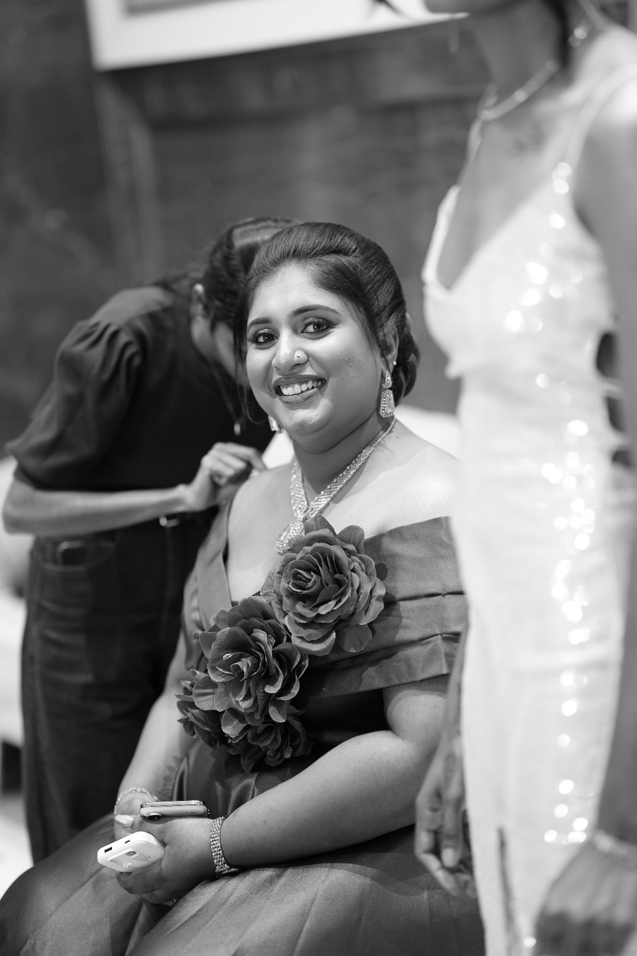 Black and white photograph of Dr. Ashvini Sundararaju backstage with roses