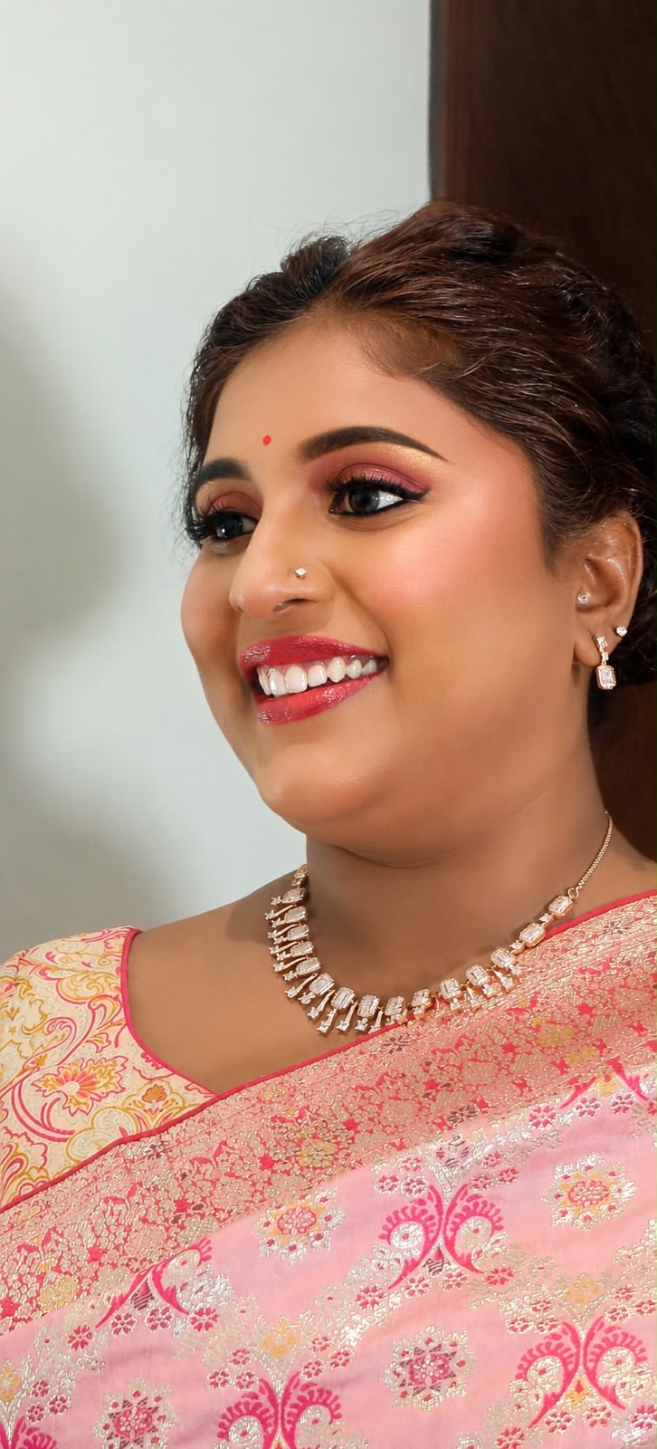 Close-up of Dr. Ashvini Sundararaju in pink brocade