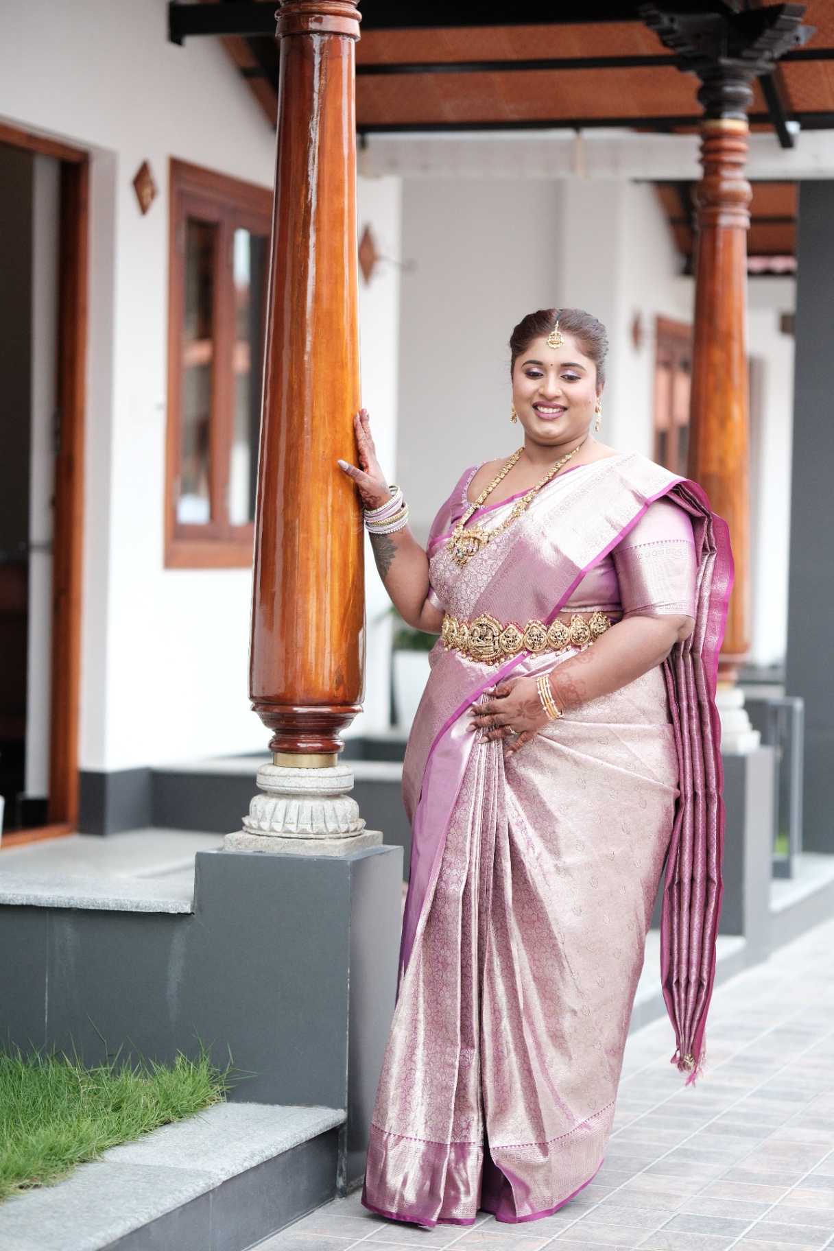 Dr. Ashvini Sundararaju on a verandah in a lilac Kanjeevaram saree