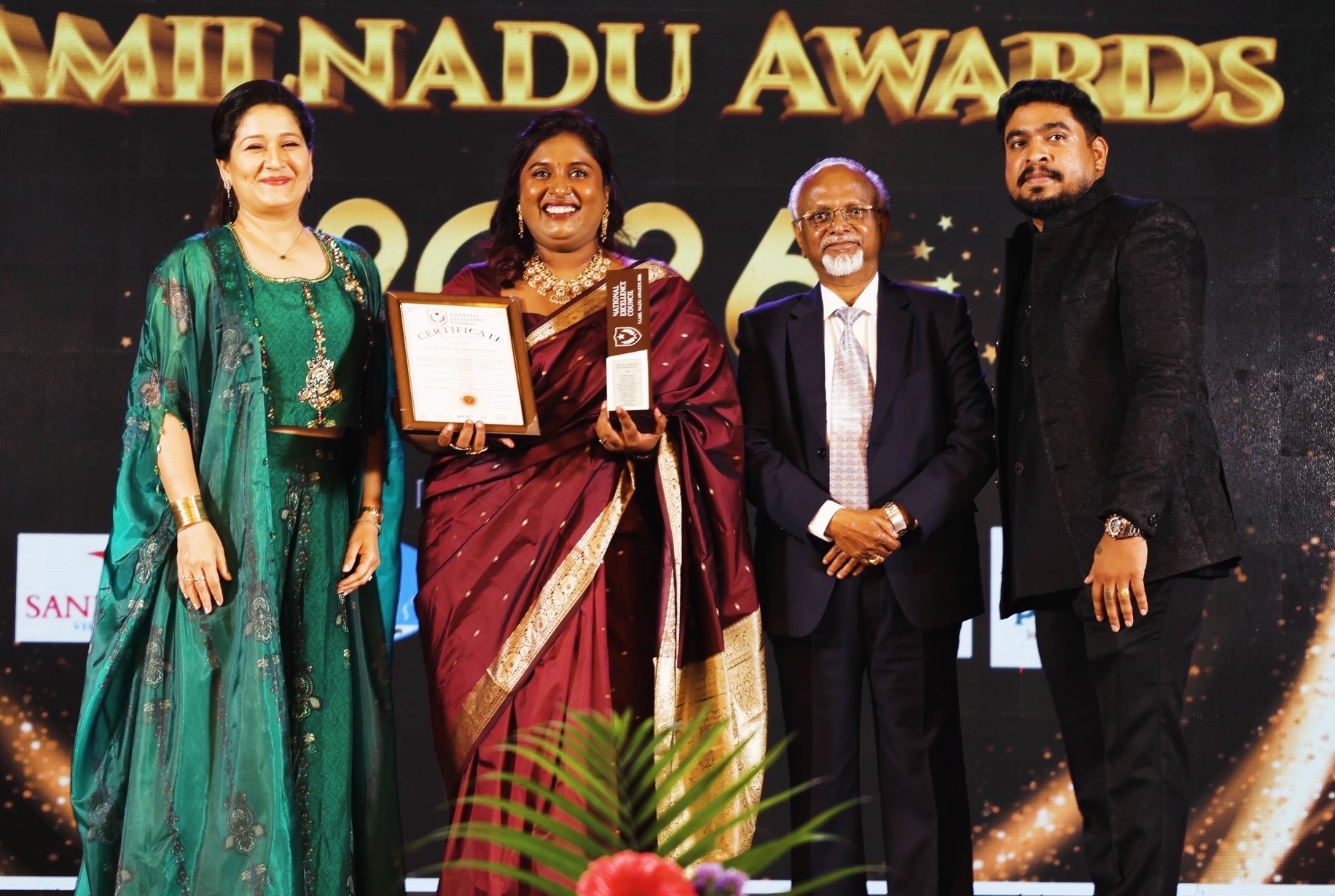 Dr. Ashvini Sundararaju on stage at the Tamil Nadu Excellence Awards